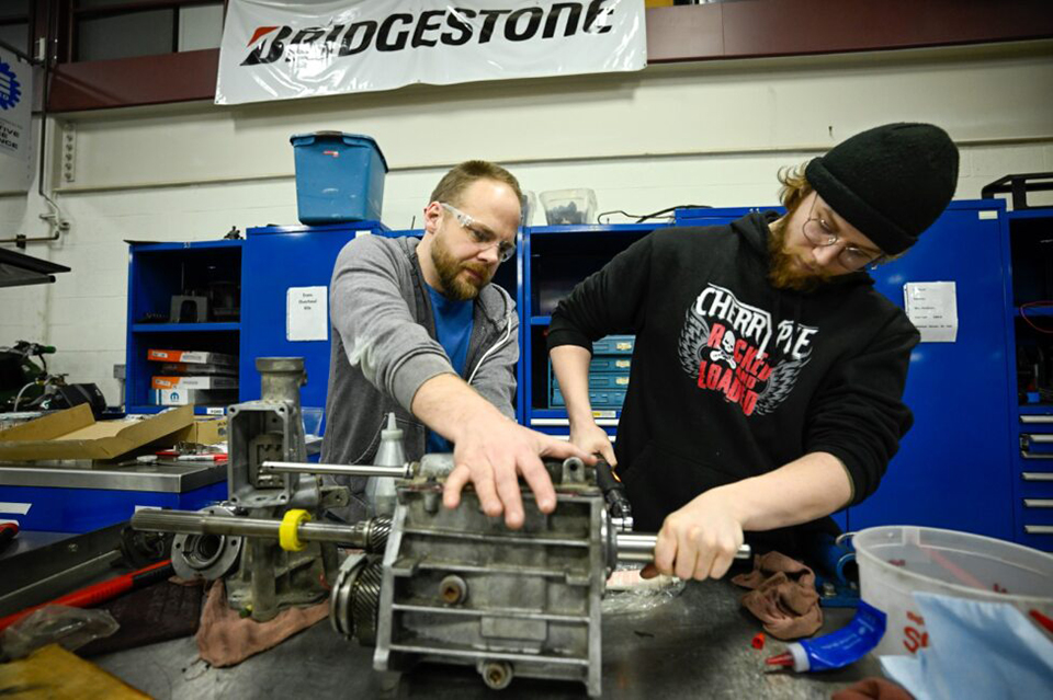 Automotive Technician program students Richard Anderson and Andrew Gonzalez assess a vehicle. 