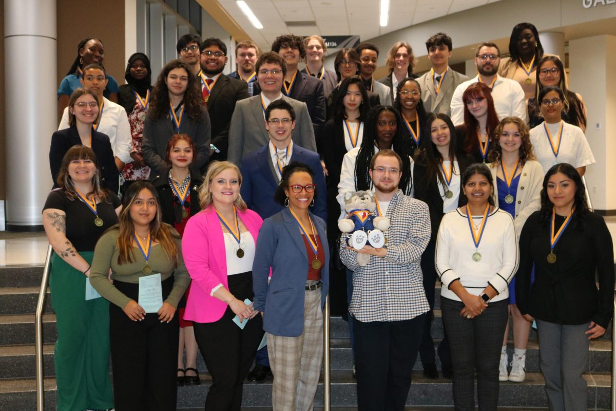 Newly inducted members of Madison College’s Beta Beta Psi Chapter of the Phi Theta Kappa honor society gather for a group photography following the ceremony on March 15. The induction ceremony was held in Madison College’s Mitby Theater.