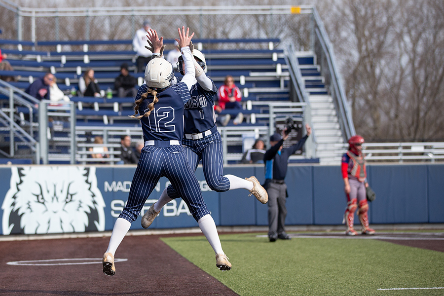 Karis+Paulson+%2812%29+and+Mackenna+Schultz+%281%29+celebrate+together+after+a+run+scored.