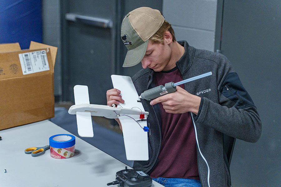 Aviation Club Treasurer Hakon Heggland makes repairs to one of the planes.