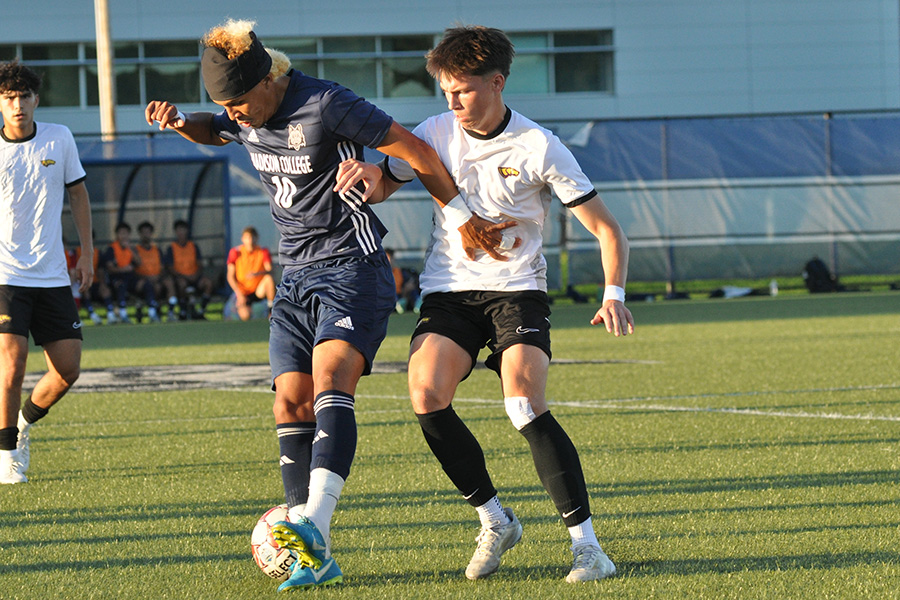 Madison College men’s soccer player Rodrigo Lasso holds off a defender during a scrimmage with UW-Stevens Point.