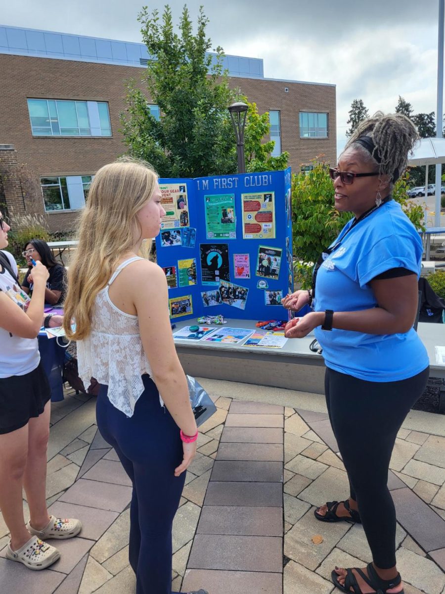 I'm First Club advisor Ra’Shi Common visits with a student at Campus Fun Day at the Goodman South Campus on Sept. 23.