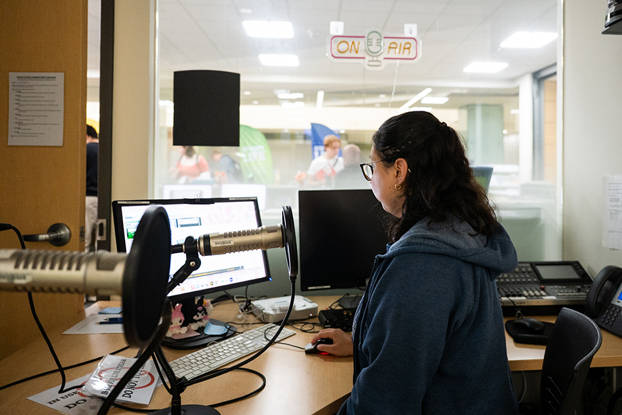 Paola Ramos Ramirez, the Clarion Radio general manager, works on her show in the college’s radio studio in the Student Life Office, Truax Room B1260.