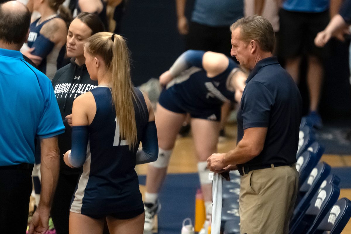 Madison College athletic trainer Mike Van Veghel, right, is stationed near the team bench during a recent volleyball match.