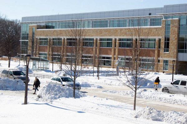 A look at the Madison College Health Building with snow piled in front.