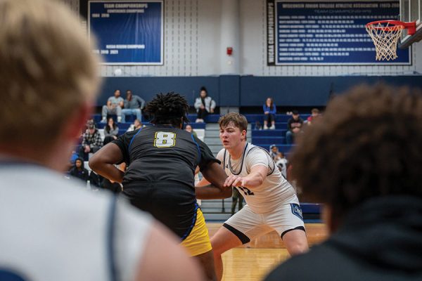 Madison College’s Carter Sullivan (12) plays defense against Blackhawk Technical College on Jan. 10 as teammates look on from the bench.