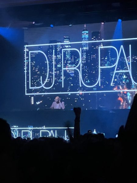 Rupaul disc jockeying in front of raving fans at the Rave in Milwaukee.
