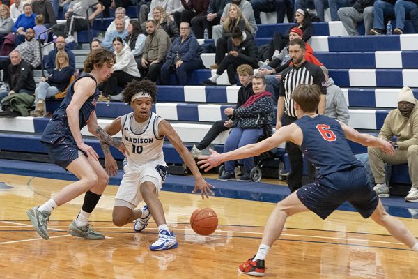 Photo of a men's basketball player dribbling.