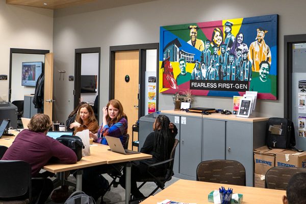 Photo of students and staff visiting in a lounge area