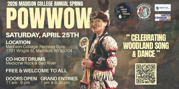 Native American person standing with ceremonial dancing garb.