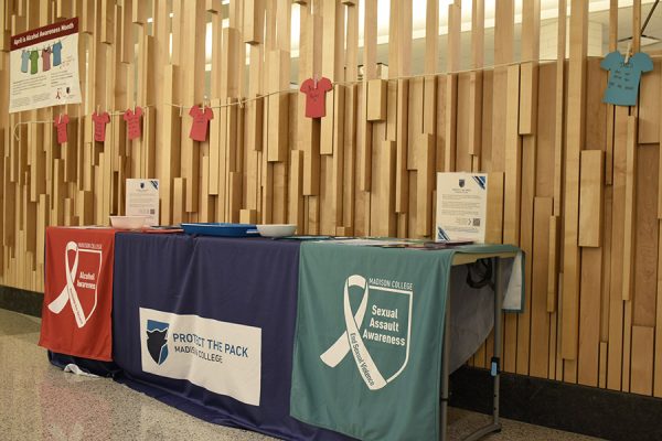 A sexual assault awareness banner is draped across a table.