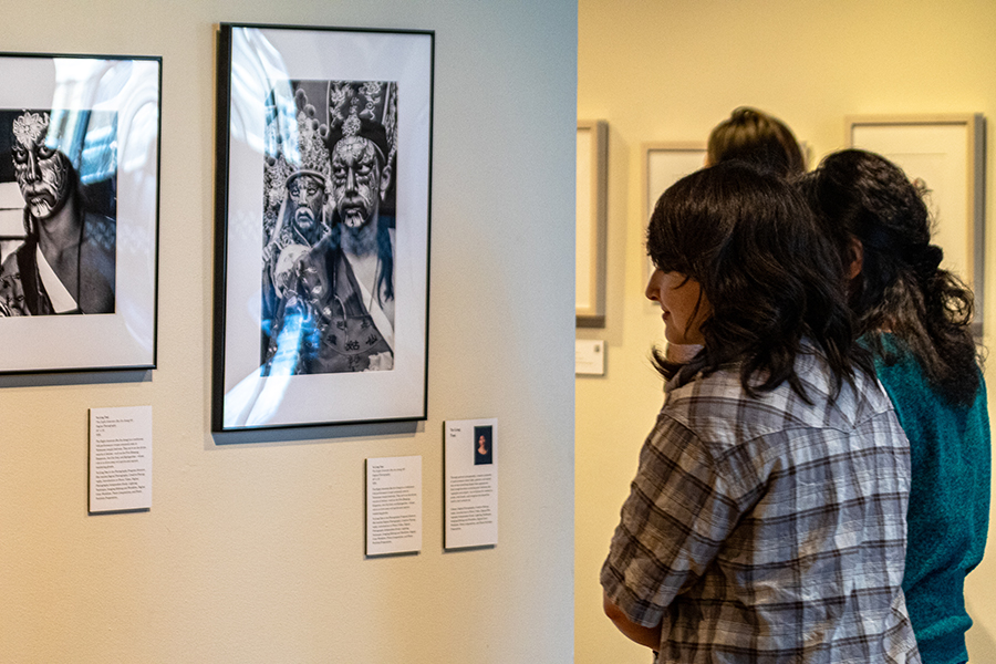 Two women look at a black and white image in the Truax Gallery.